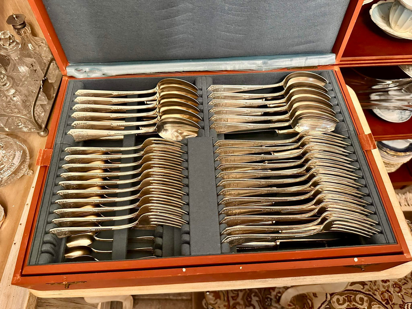 Exquisite 70-piece cutlery set for 12 guests, featuring elegant E.S. monograms.
