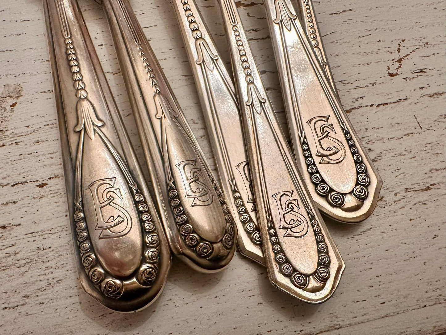 Exquisite 70-piece cutlery set for 12 guests, featuring elegant E.S. monograms.