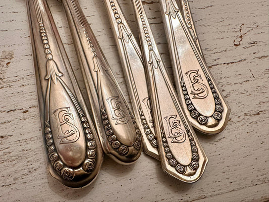 Exquisite 70-piece cutlery set for 12 guests, featuring elegant E.S. monograms.